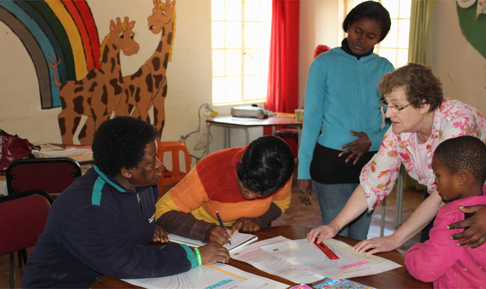 Noreen Oliver explaining CDC growth charts to care workers at Ledig OVC centre (South Africa)