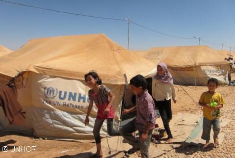 Refugees in Zaatri camp, Jordan, receive buckets, jerry cans and other relief items from UNHCR to help them survive and live in the camp while away from home. UNHCR’s water and sanitation partner UNICEF have installed water points in the camp. Photo: UNHCR / A. Rummery