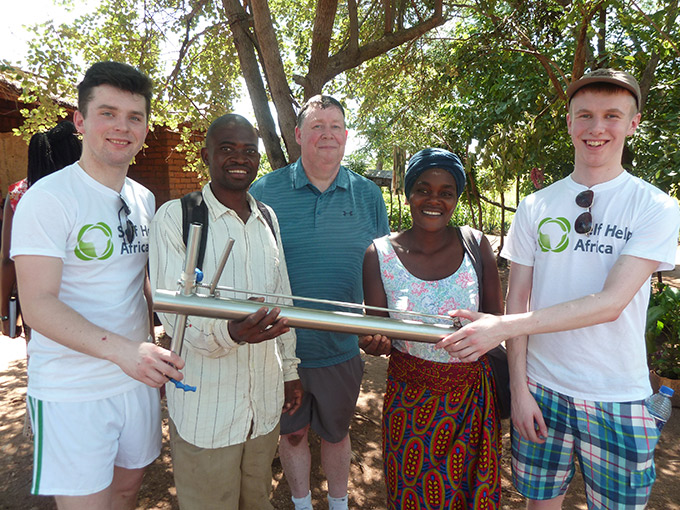 Diarmuid Curtin (left), teacher Donal Enright (center) and Jack O'Connor (right) with farmers Memory Pemba and Alick Bamusse in Kwitanda village, Balaka. Credit: Gorta Self Help Africa